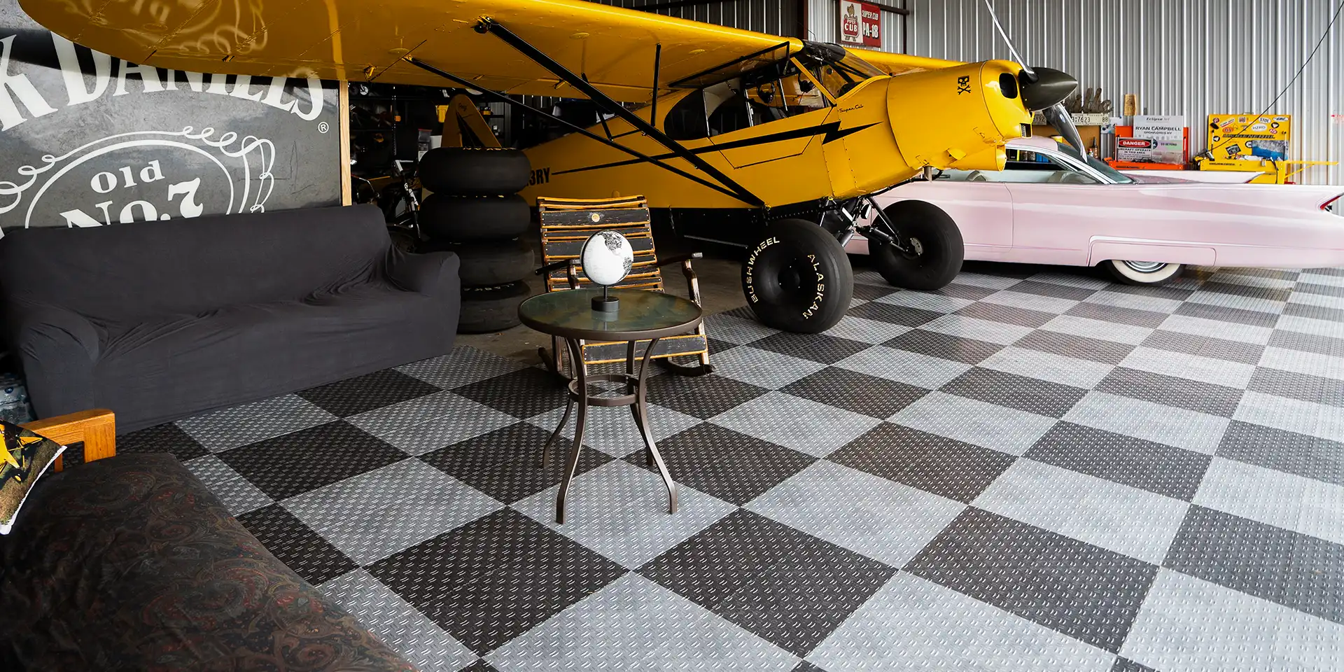 STOL plane and Cadillac A STOL plane and Cadillac parked in a hanger with GarageTrac.