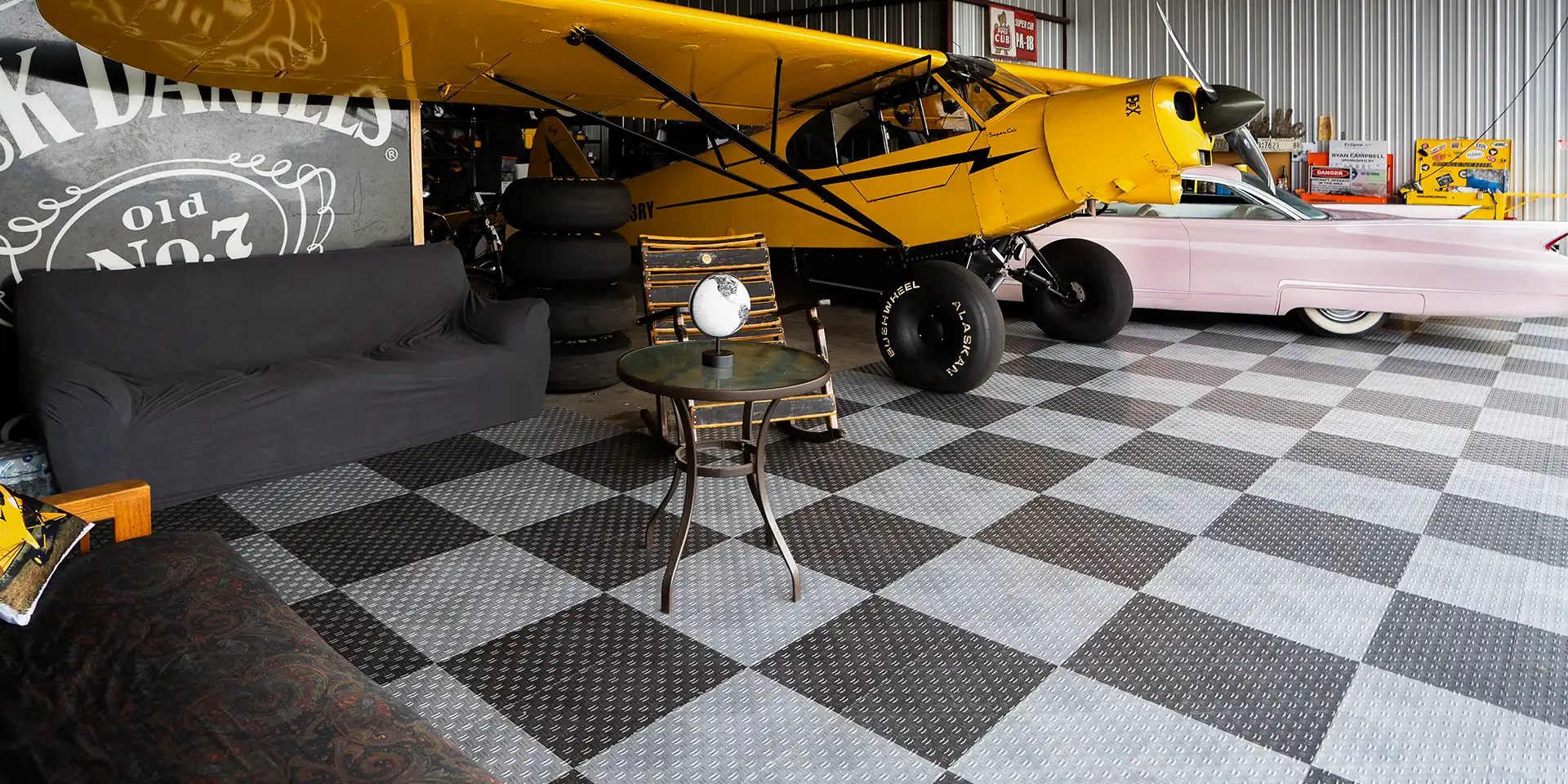 STOL plane and Cadillac parked in a hanger with GaragTrac