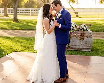 Bride and groom take their first dance on a Snaplock Plus Dark Maple dance floor